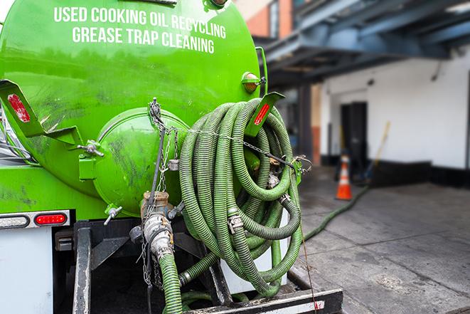 a technician pumping a grease trap in a commercial building in Cleveland, OH